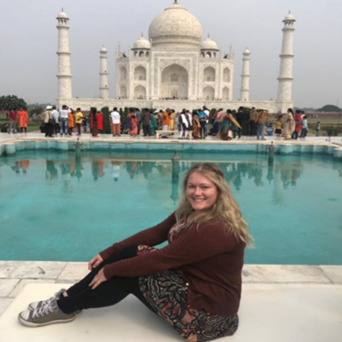 Photograph of Kristy Jones, Co-Ordinator of the ESF Employability programme, sitting in front of the Taj Mahal in India Photograph of Kristy Jones, Co-Ordinator of the ESF Employability programme, sitting in front of the Taj Mahal in India