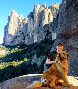 Photograph of Marc Luxon, Employability Support Worker, with his dog in the outdoors on a hike