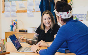 student and tutor sitting at desk