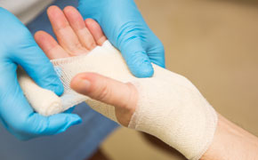 close up of a hand being bandaged