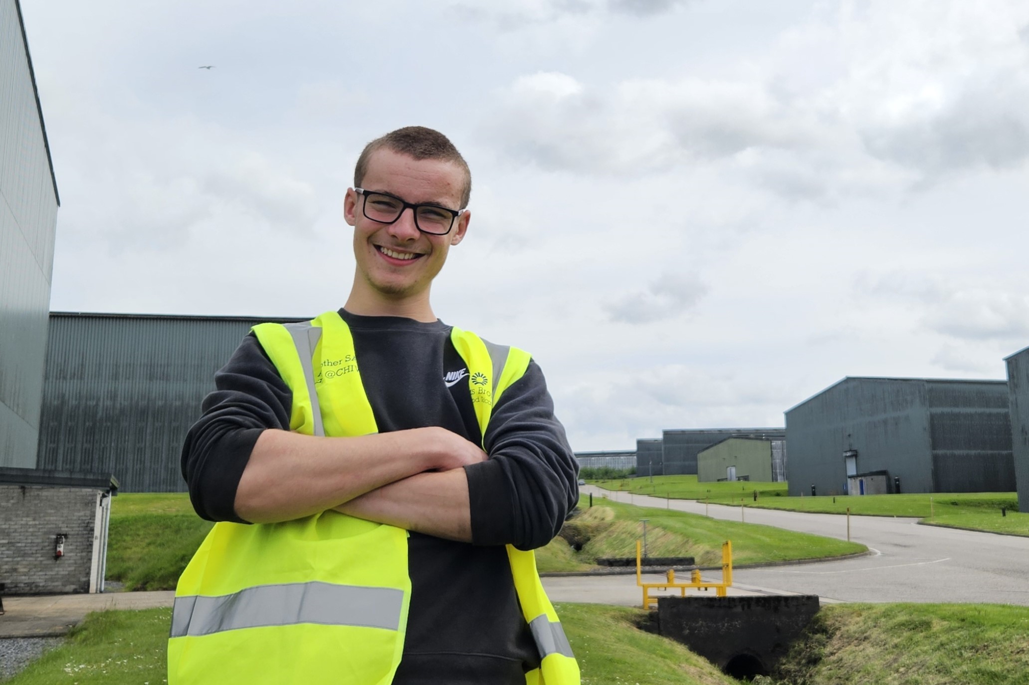 A photograph of employability client, Harry, standing outside with distillery bond buildings behind him A photograph of employability client, Harry, standing outside with distillery bond buildings behind him