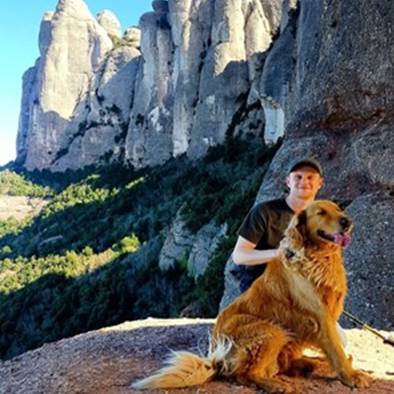 Photograph of Marc Luxon, Employability Support Worker, with his dog in the outdoors on a hike Photograph of Marc Luxon, Employability Support Worker, with his dog in the outdoors on a hike