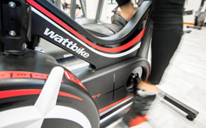 Close up of student using exercise bike gym equipment
