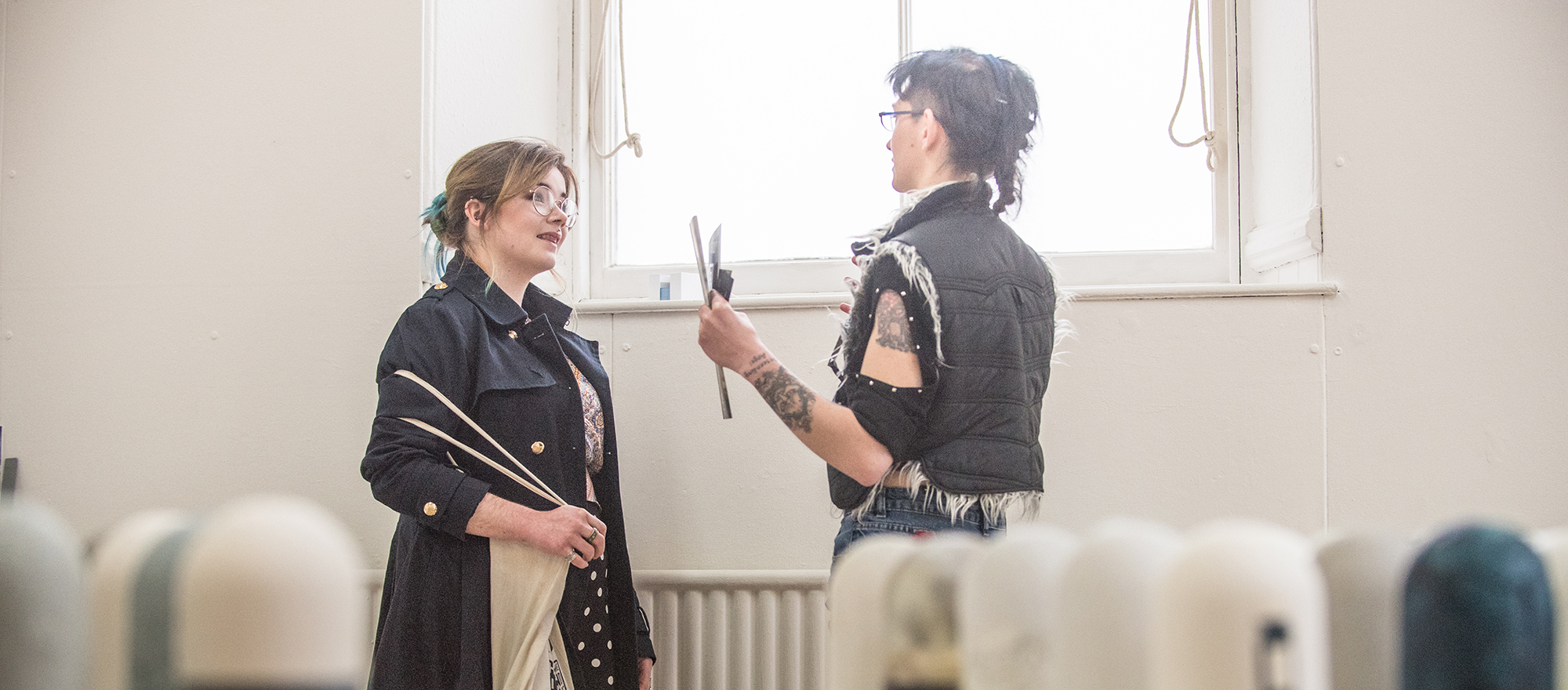 Two women smiling and chatting at the 2019 Moray School of Art degree show