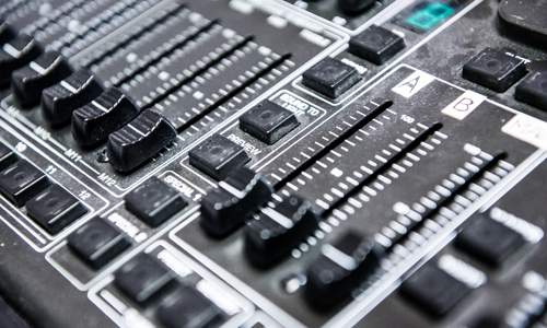 A close up photograph of a soundboard used for audio production A close up photograph of a soundboard used for audio production