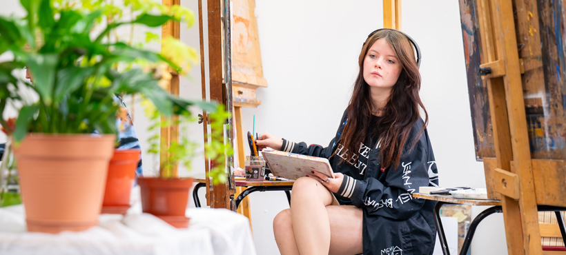 art student sitting at an easel