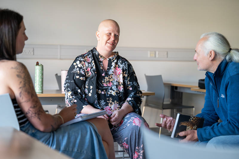 photo of counselling students sitting in a group of three doing a therapy appointment practice photo of counselling students sitting in a group of three doing a therapy appointment practice