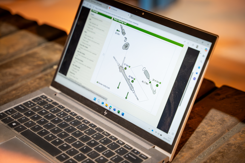 Photo of a laptop. On the screen is a schematic of a power steering rack Photo of a laptop. On the screen is a schematic of a power steering rack