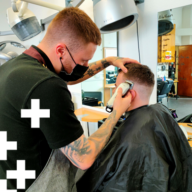 photo of barbering student working on a client