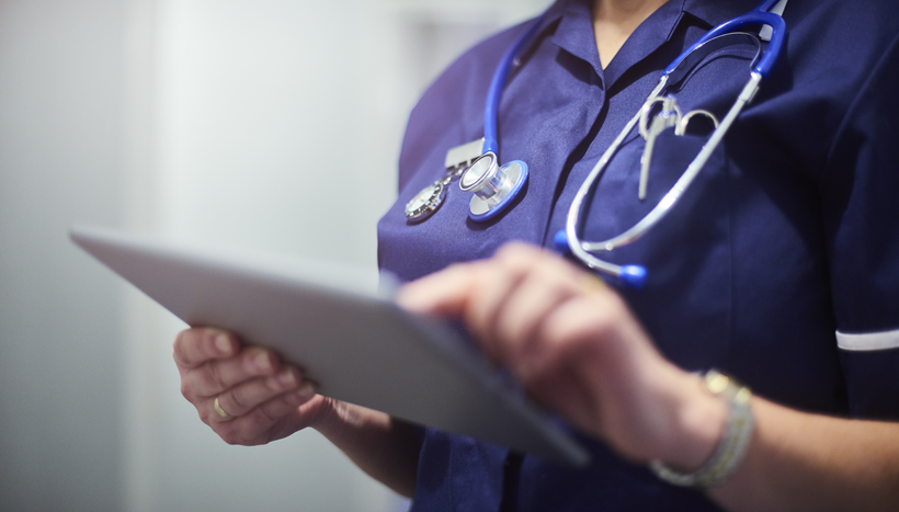 Close up image of a nursing uniform. The nurse wearing it is holding a clipboard and wearing hospital equipment Close up image of a nursing uniform. The nurse wearing it is holding a clipboard and wearing hospital equipment