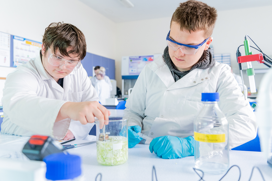 Photo of two male scientists doing an experiment in a lab Photo of two male scientists doing an experiment in a lab