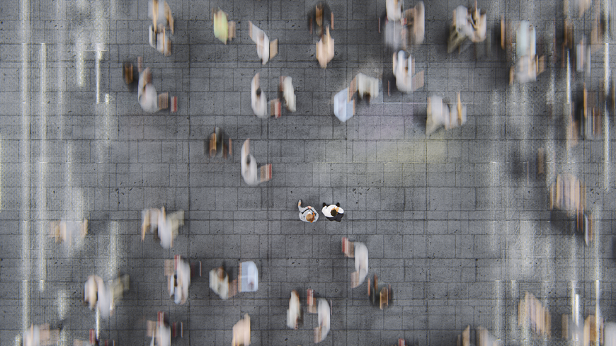 Top down image of people walking. Most of the people are blurry due to the motion of the walk however two are in focus Top down image of people walking. Most of the people are blurry due to the motion of the walk however two are in focus