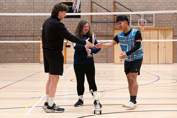 : Zeke Ferdinand Balanquit (right), president of the basketball team at UHI Inverness, shaking hands with Stuart Fraser (left), Active Campus Coordinator at Inverness Campus, and Amanda Fleet (middle), Sports Development Coordinator at HISA.