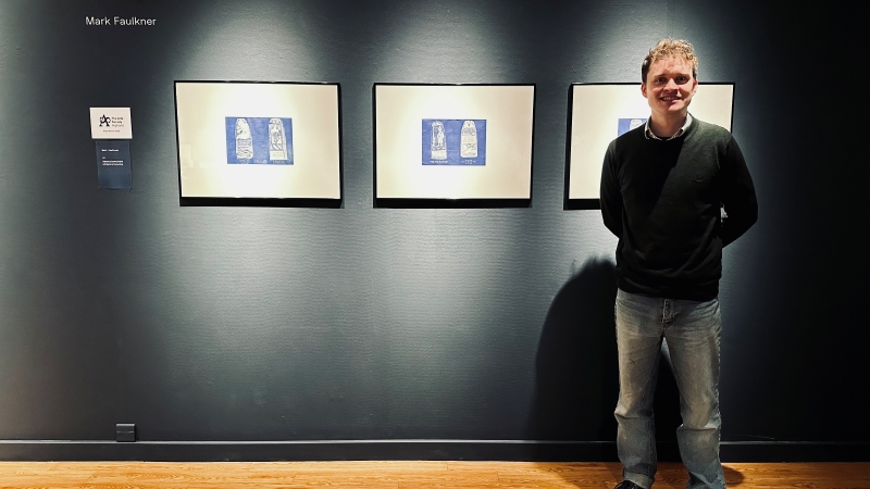 Mark Faulkner standing in front of artwork
